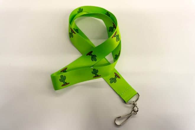 The Phoenix Sky Harbor international airport compassion cacti lanyard has a green background with saguaro cactus patterns dotting the lanyard.