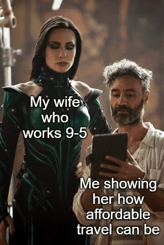 Cate Blanchette is standing over Thor Ragnarok director, Taika Waititi. Over Cate are the words, "My wife who works 9-5." On Taika, "Me showing her how affordable travel can be." Cate and Taika internet meme.