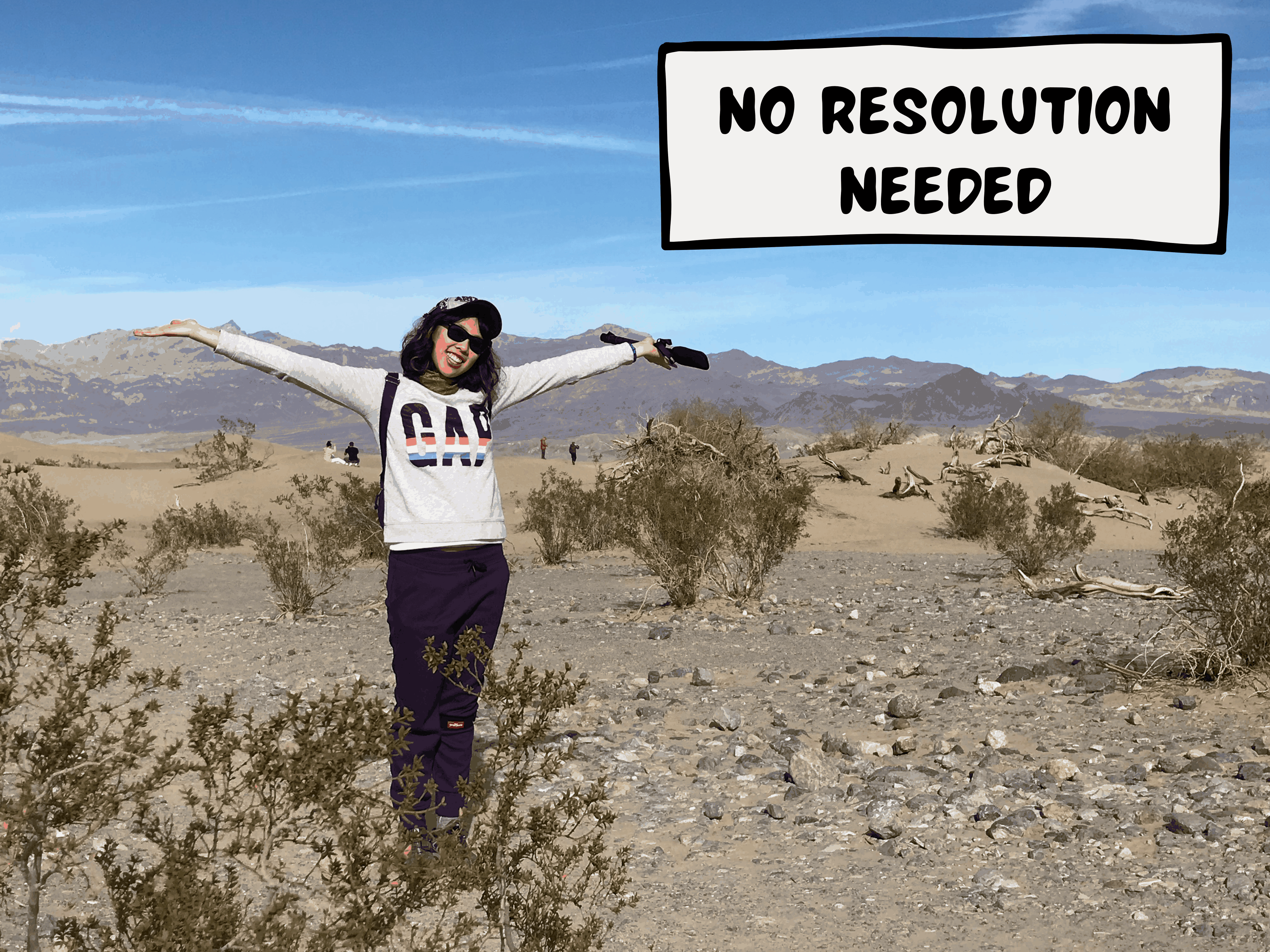 Meggie is wearing a white sweatshirt and purple pants. She is raising her arms in the sky and smiling. She is standing in the desert and sand dunes of Death Valley National Park in southern California, United States. A comic text box says, "no resolution needed."