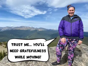 Allie from the Hoppy Passport is standing on a gray mountainside overlooking the forest and a mountain range. She is wearing a black jacket and floral pants. In a text comic bubble, she says, "Trust me... you'll need gratefulness while moving!"