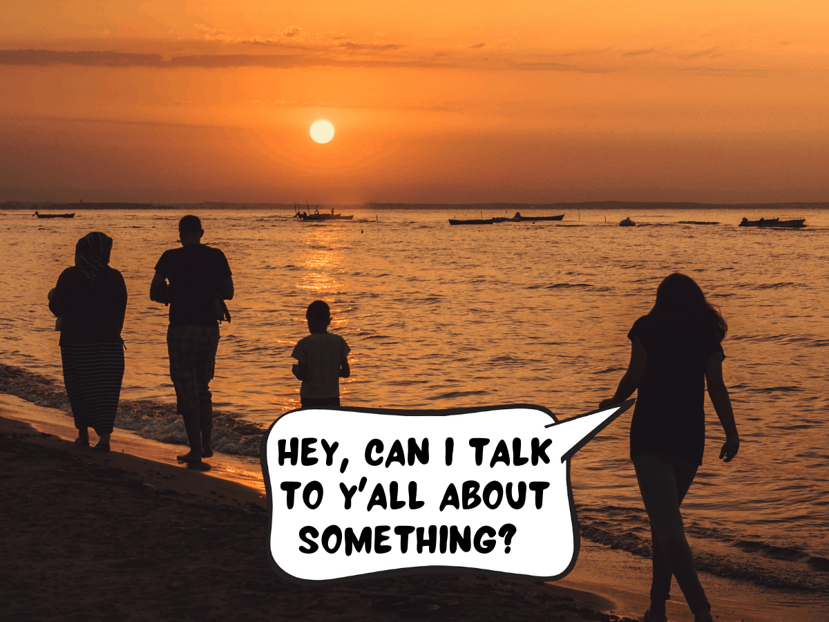 A family of four is silhouetted while walking along the beach at an orange sunset. One of the family members in a comic text bubble says, "Hey, can I talk to y'all about something?"