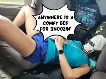 Meggie, in a blue tank top and shorts, is sleeping with a white ball cap covering her face. She is sleeping in the aisle of a small traveling bus. Her legs are resting on a seat while her head is resting against a pile of suitcases in the back of the bus, which is traveling through Costa Rica. In a comic text bubble, it says, "Anywhere is a comfy bed for snoozin'"