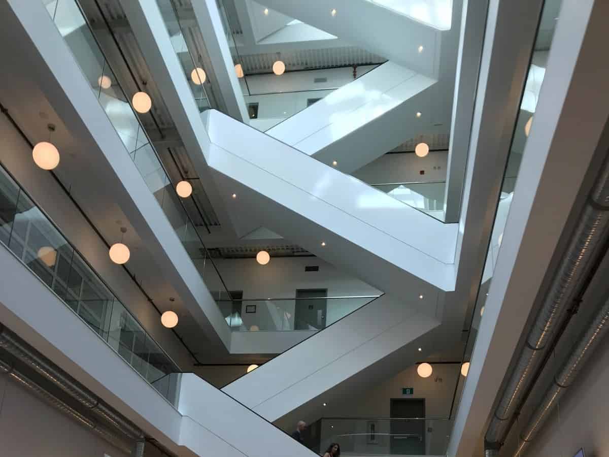 The Okanagan Centre for Innovation in Kelowna, British Columbia, Canada. The interior has white walls, floors, and a grand staircase.