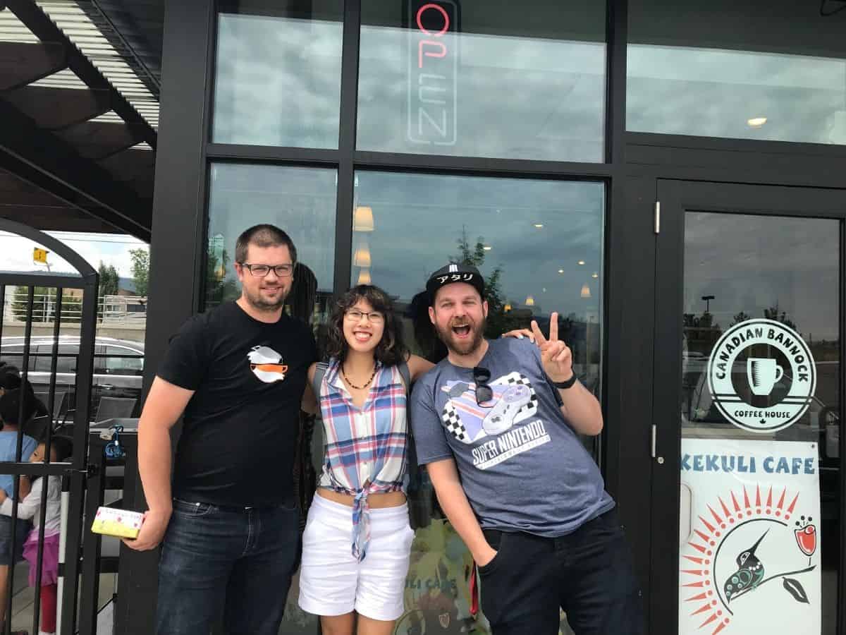 Meggie is standing with Chris Gliddon/Polo Field in front of the Kekuli Cafe, Kelowna, British Columbia, Canada. Chris is wearing an Atari cap and Super Nintendo Entertainment system t-shirt.