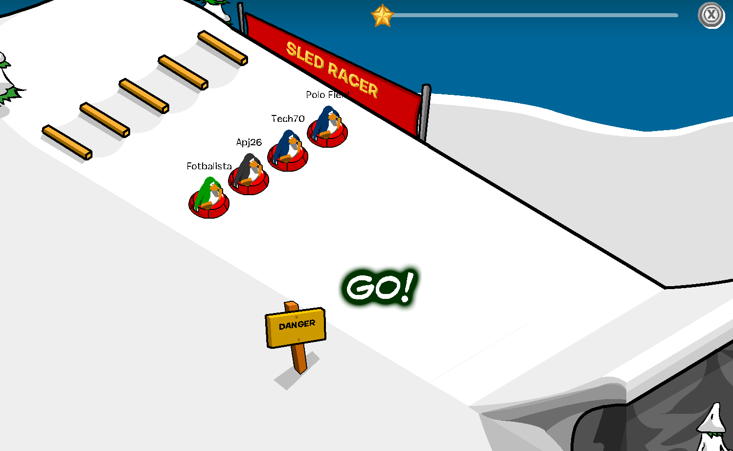 A screenshot of Club Penguin's Sled Racing mini-game. Four penguins, including Meggie (known as Tech70 the penguin) and Chris Gliddon (known as Polo Field the penguin), are racing down the white snowy slopes.