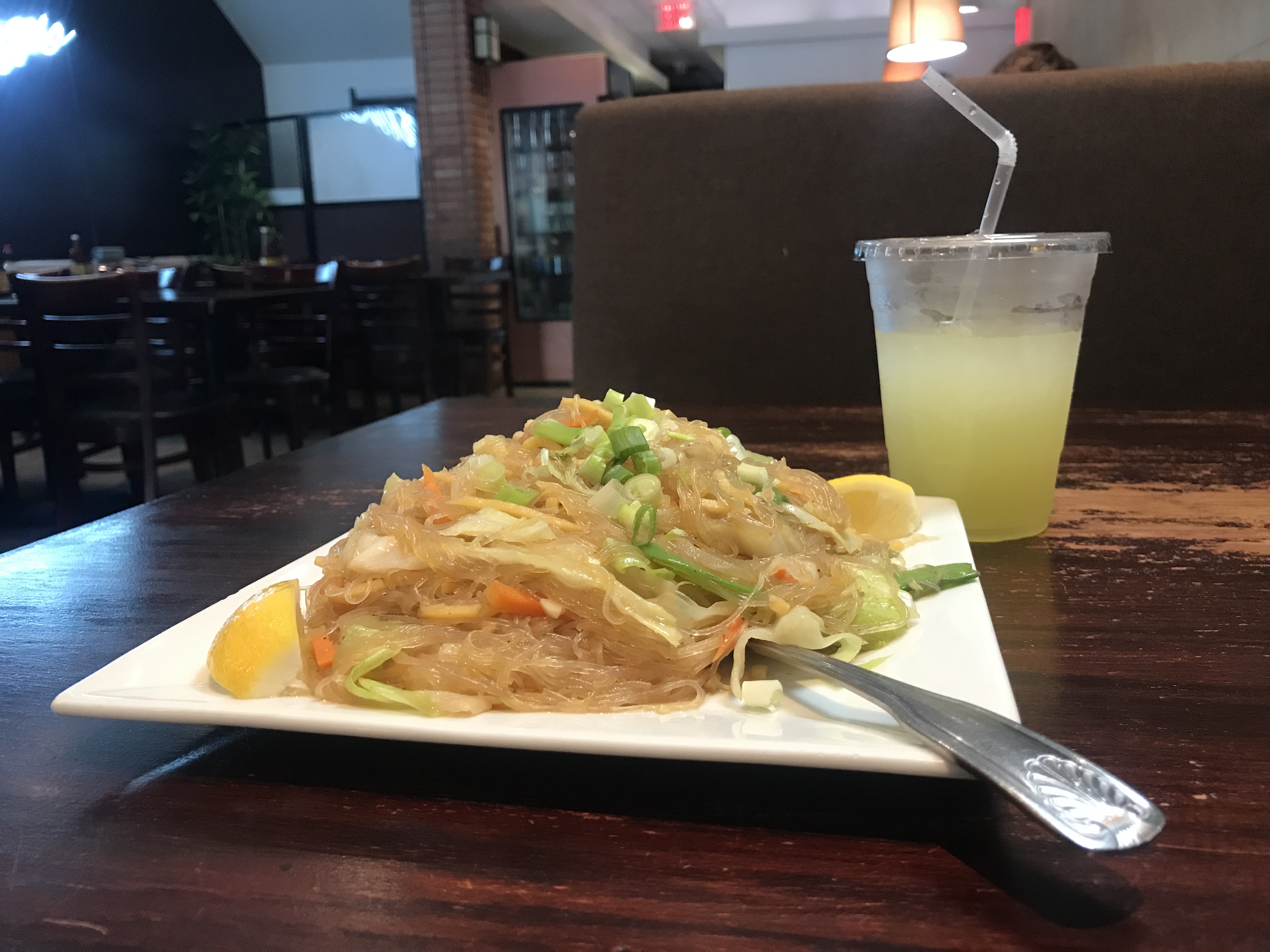 A large plate of miki bihon, Filipino pancit noodles made from rice and egg. Includes vegetables, such as scallions/green onions. Max's Restaurant, Jersey City, New Jersey, United States of America