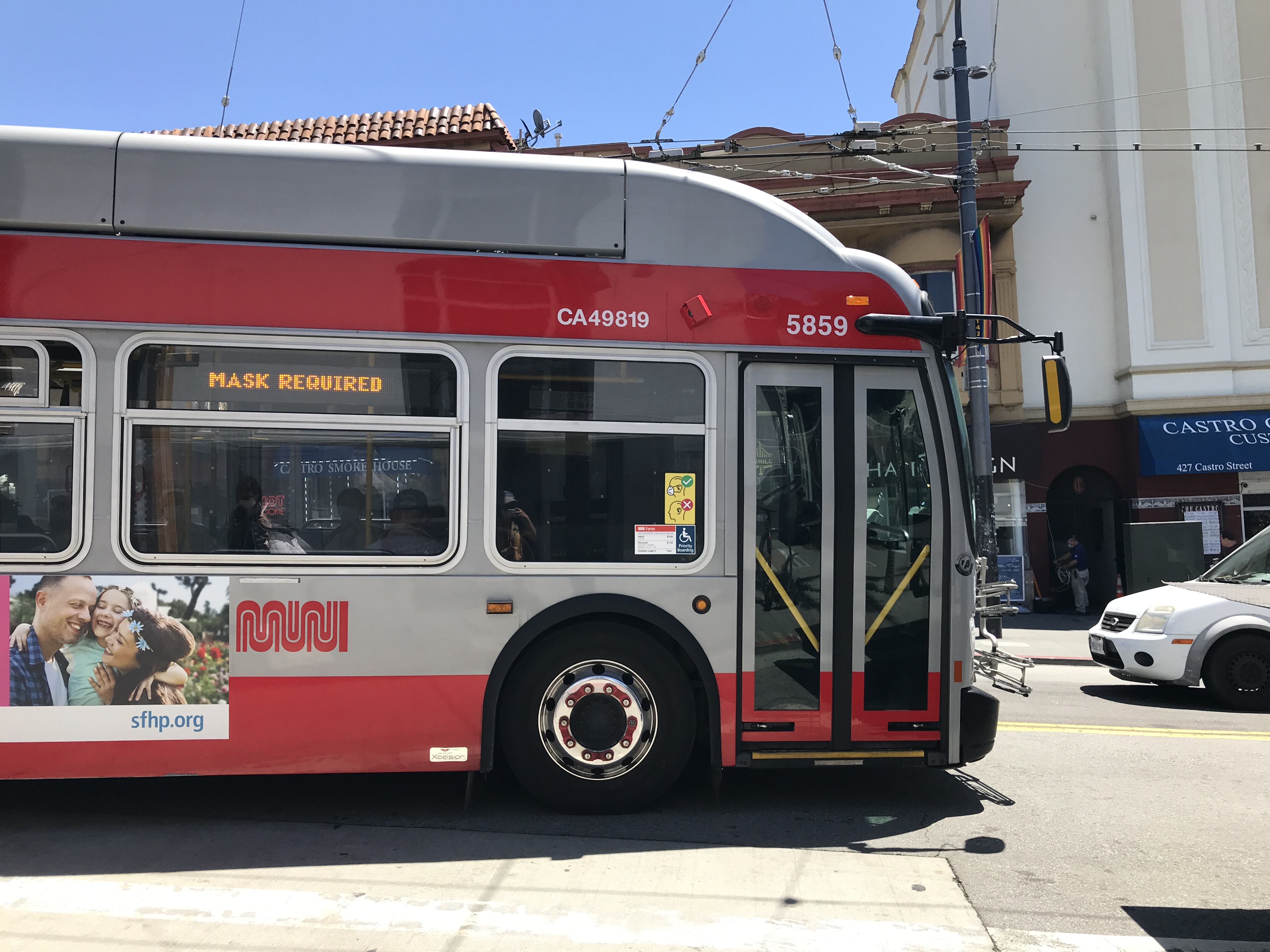 The front of a white and red MUNI bus viewed from the side. The Castro District, San Francisco, California, United States of America.