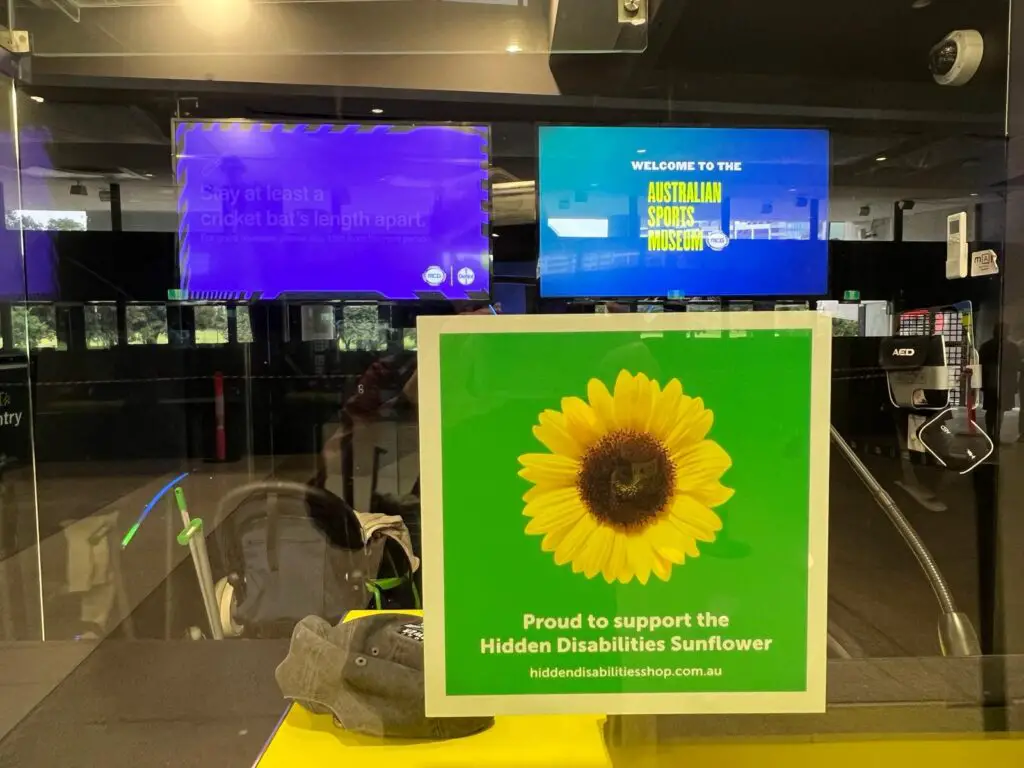 A green sign with a Sunflower logo posted at the ticket counter of the Australian Sports Museum in Melbourne, Australia.