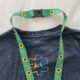 Green Sunflower Lanyard against a Visit Mesa shirt with a puzzle piece representing autism
