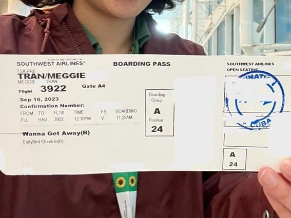 A close-up of Meggie's boarding pass that they're holding.