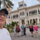 Meggie with their tour group and leader smiling for a selfie in front of a historic house-turned-restaurant nearby Hotel Jagua in Cienfuegos, Cuba.