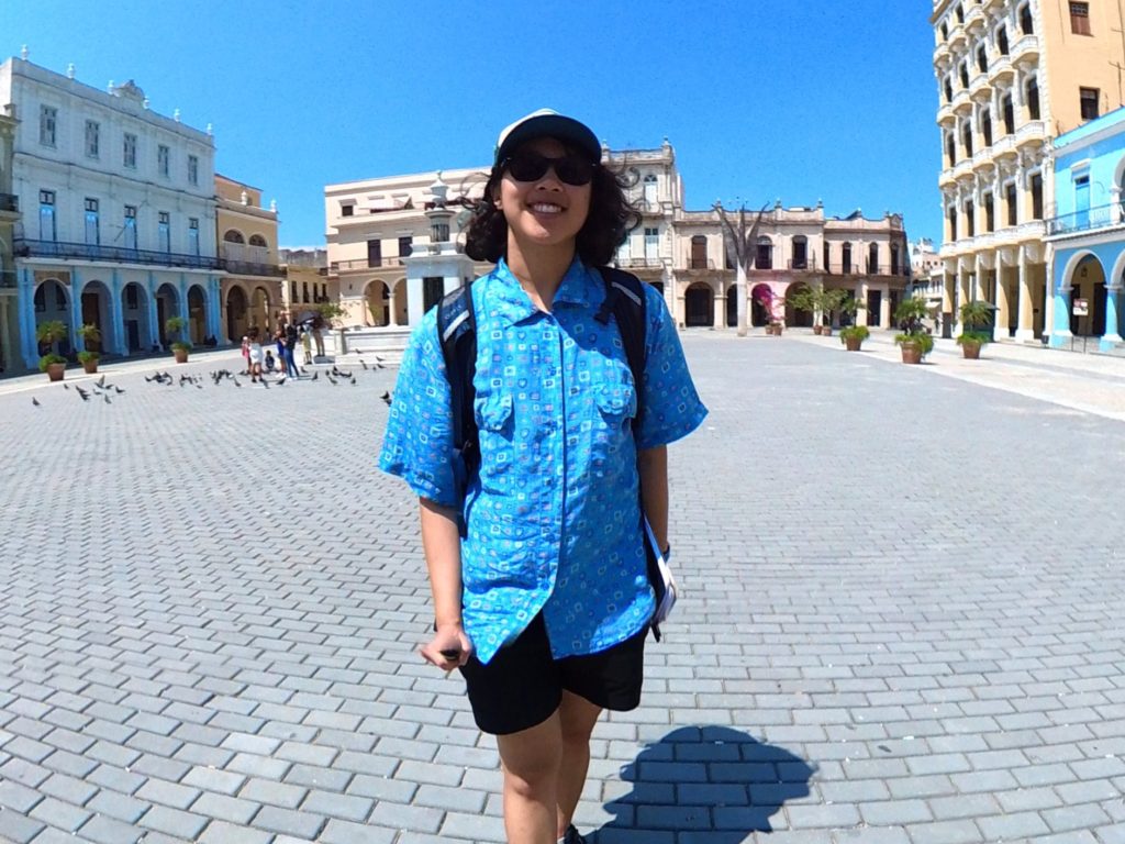 Meggie on a historic walking tour through Havana. They are wearing a blue shirt in a wide public square.