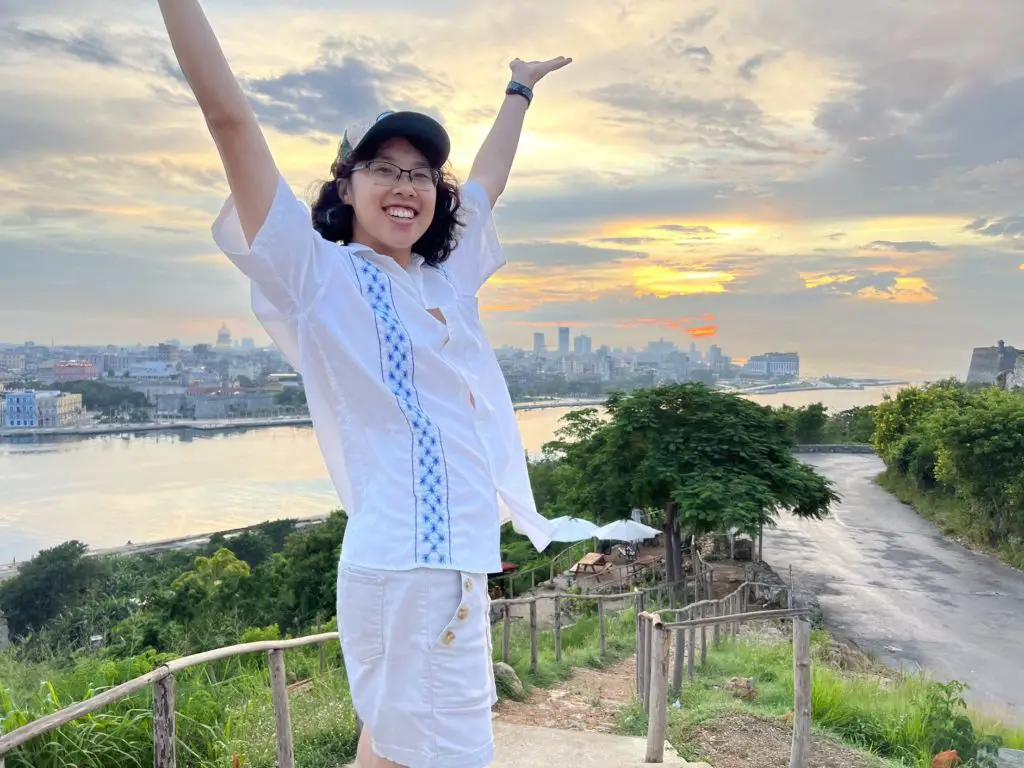 Meggie poses with a Havana sunset by the bay